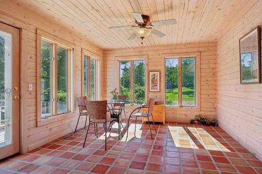 3 Season Porch with walls of glass and door to decks and pool
