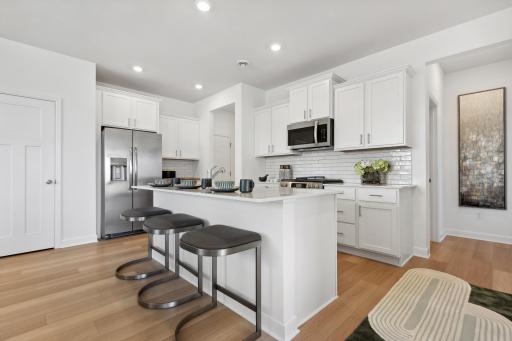 (Photo of decorated model, actual homes colors and finishes will vary) Open and naturally bright, the home's kitchen space is highly desirable