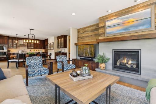 A dramatic gas fireplace with tile and reclaimed wood accents anchors the living space