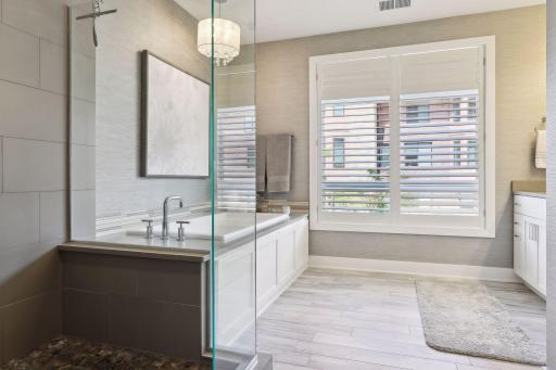 Natural light provides a tranquil ambiance in the spa-like primary bath