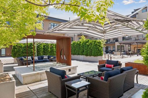 Gas fireplace, inviting seating areas, and pretty landscaping are highlights of the courtyard