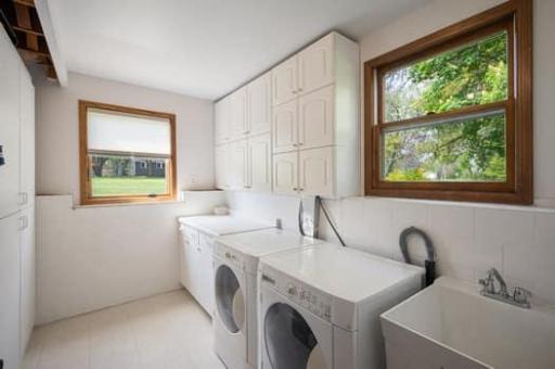No dark laundry room in this home. There is sunlight west and the north plus storage space for all of your supplies.