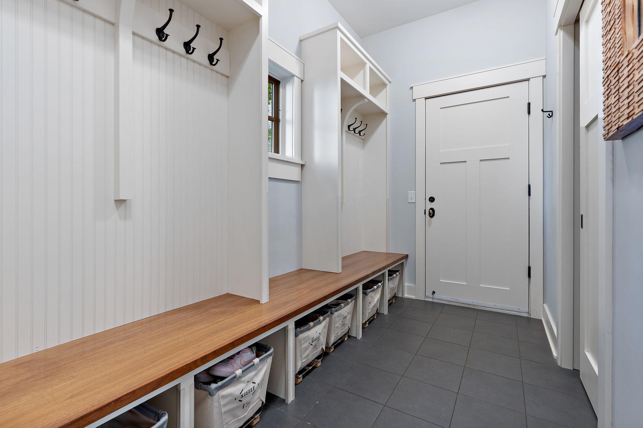 Massive mud room off the finished garage with a dog wash station!