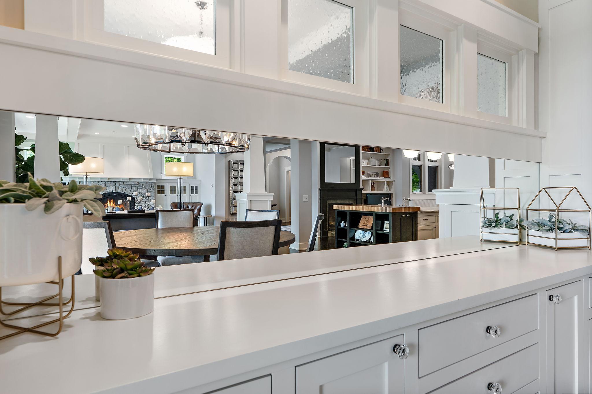 Custom built-in buffet with open dining room and beautiful lighting.