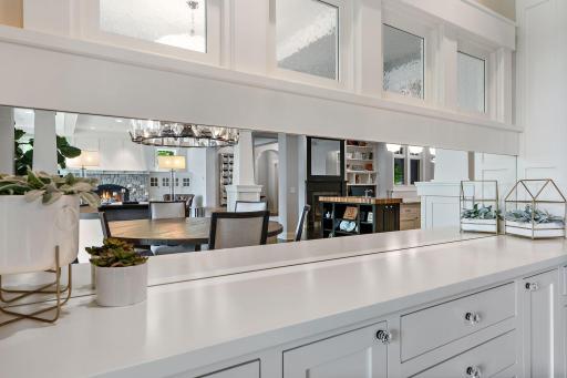 Custom built-in buffet with open dining room and beautiful lighting.