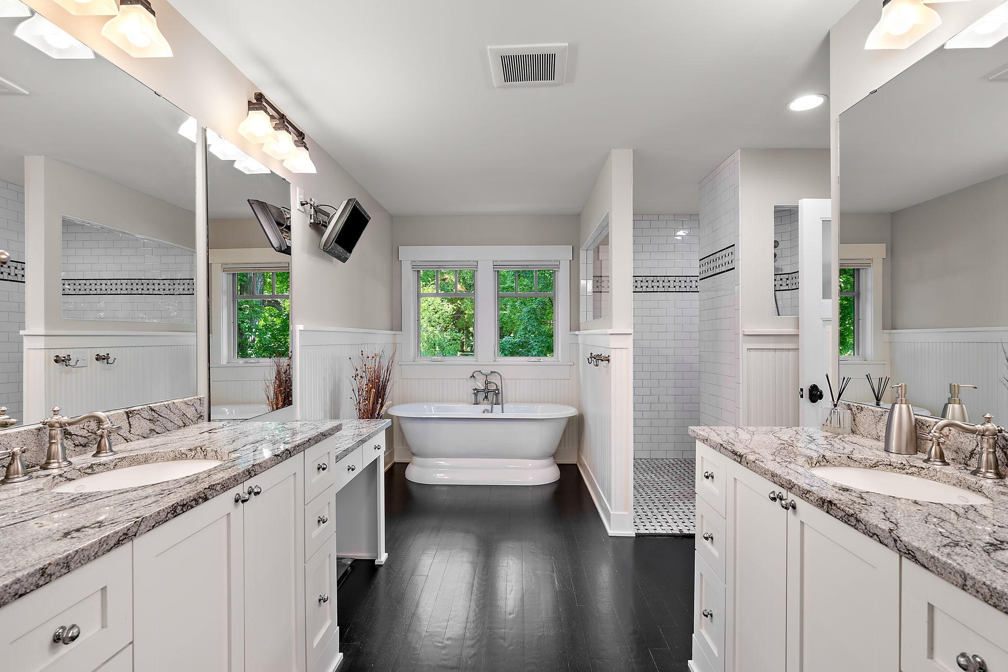 Spa-like primary bathroom with a separate tub and shower tiled to perfection!