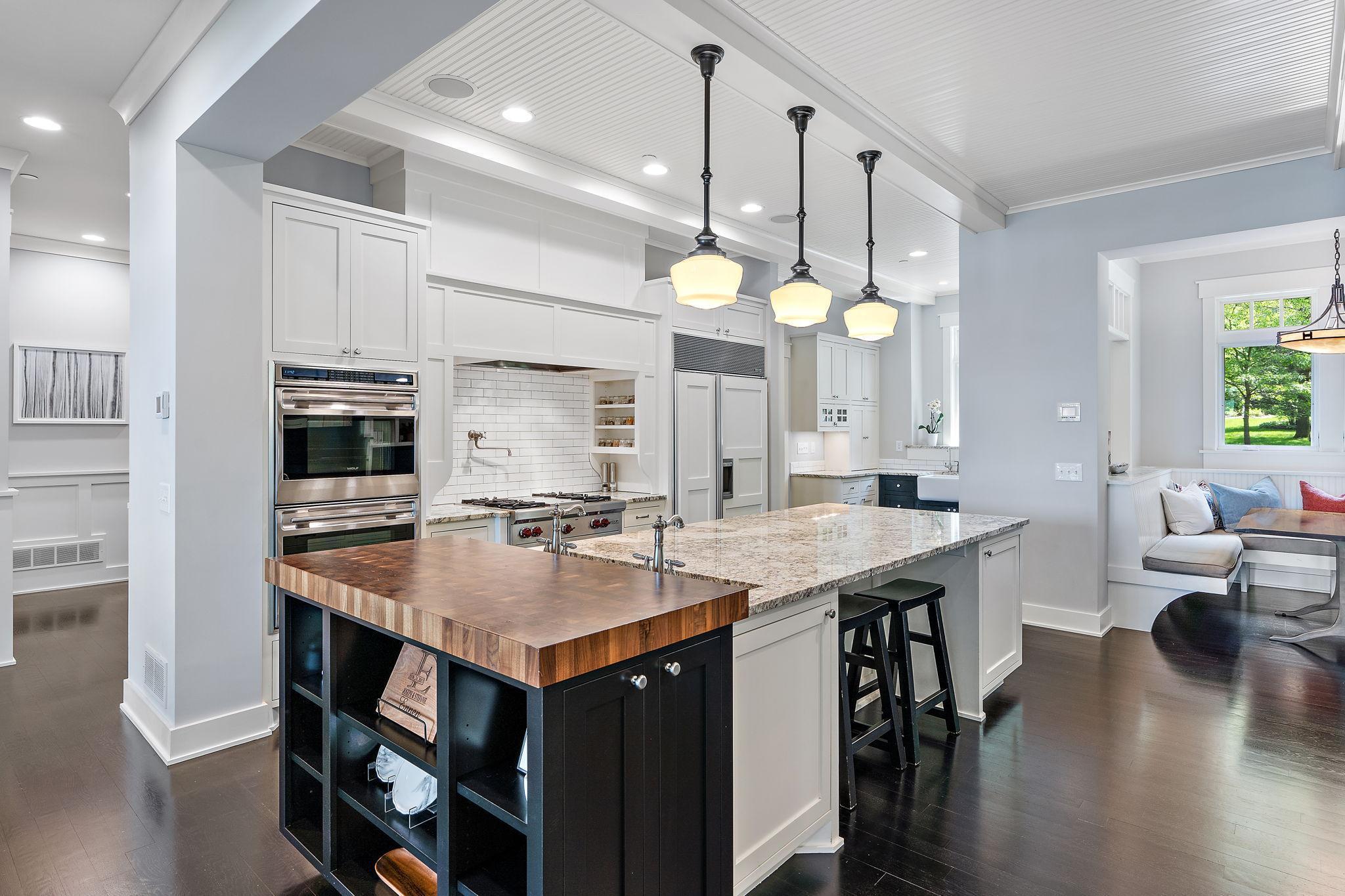 Expansive kitchen with custom cabinets that span to the ceiling with plenty of storage.