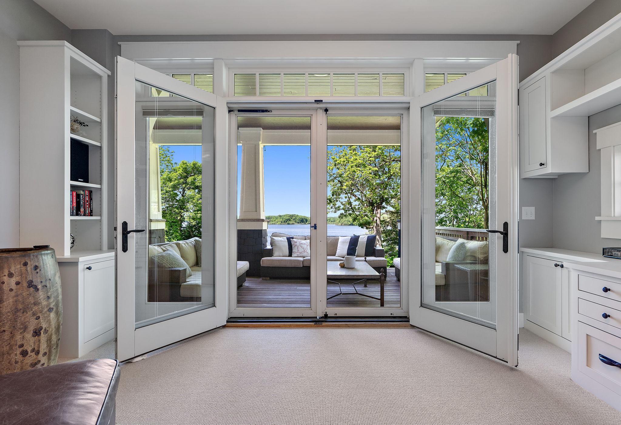 Main floor office that walks out to the deck and has spectacular lake views from all sides!