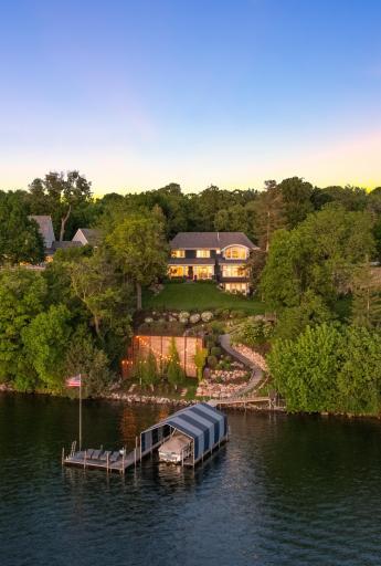 Come see this picturesque 8,300 sq. foot custom retreat on Lake Minnetonka with 101 feet of private lakeshore clear water, tennis courts & a private dock with multiple outdoor spaces sitting space!