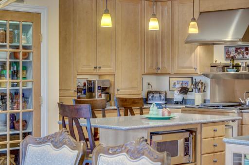 Gourmet kithen has Maple Cabinetry that extends to the ceiling for maximum storage. Imagine gathering with loved ones around large island which offers ample space for meal preparation and casual dining.
