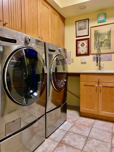 Laundry Room features tile floors, utility sink, Silestone Countertop and High Efficiency LG W/D with pedestals.