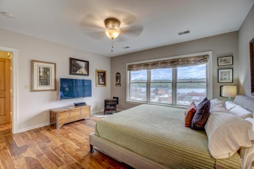 Retreat to the master suite, a private sanctuary boasting its own set of stunning windows, featuring an ensuite bath and walk-in closet