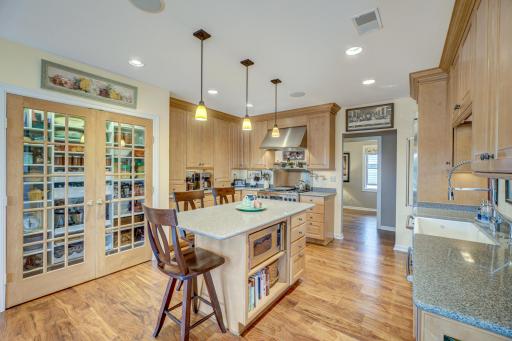 Spacious kitchen with a captivating center island, perfect for culinary enthusiasts and entertainers alike. Offers ample space for meal preparation and casual dining.