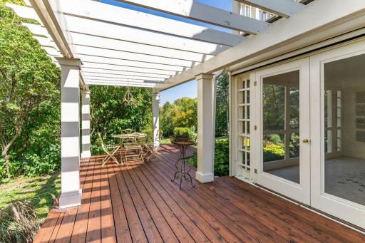 The pergola covered deck provides a serene and peaceful outdoor retreat.
