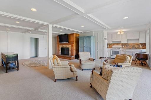 The lower level features a separate kitchenette and a stunning wood burning fireplace.