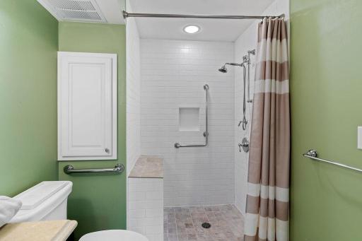 Lower level 3/4 bath has a zero entry custom tiled shower.