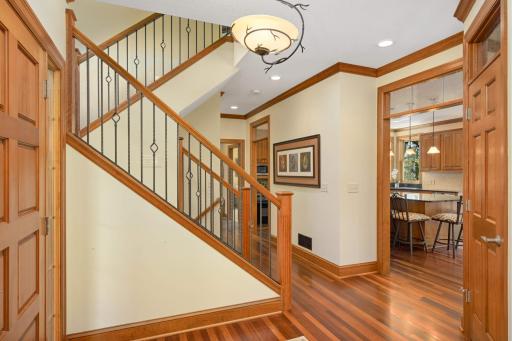 A gracious stairwell opens to the upper living quarters. The landing of the switch back stairwell offers a bench below the expansive window.