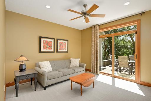 Currently used as a den, this quiet retreat offers patio access.