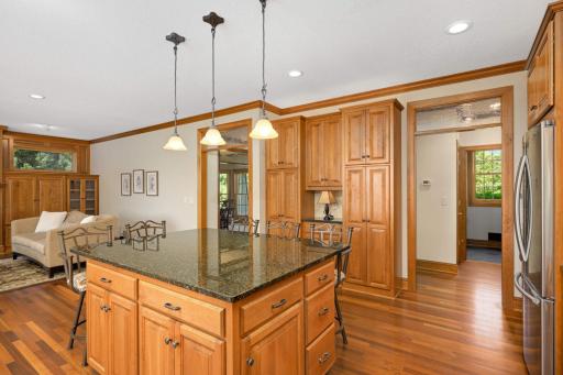 Two cased openings highlighted by seeded glass transom windows allow graceful transitions to the rest of the home.