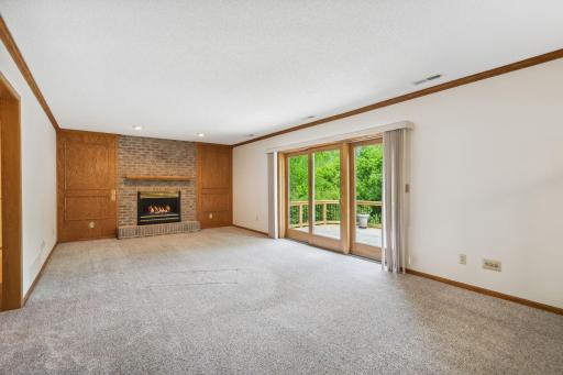 Main floor family room with gas fireplace and access to the lower tier of the 2-tiered deck