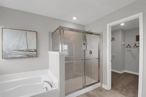The large primary suite is an oasis and offers a private bath and two walk in closets. Model photos. Options and colors will vary.