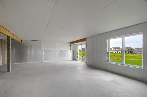 Unfinished lower level with walkout to backyard. Model photo.