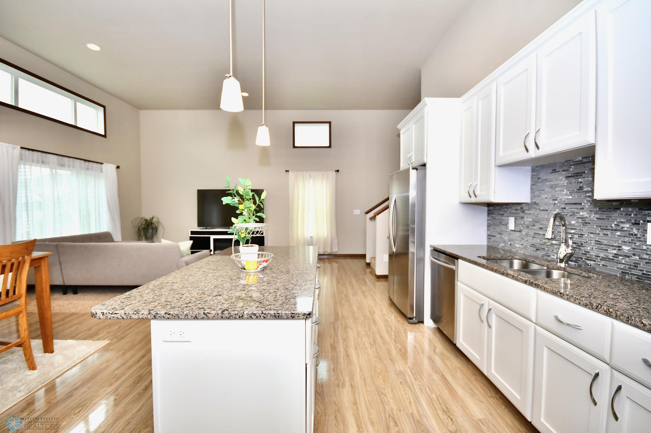 Granite Countertops throughout Kitchen; Dual Garage in Island