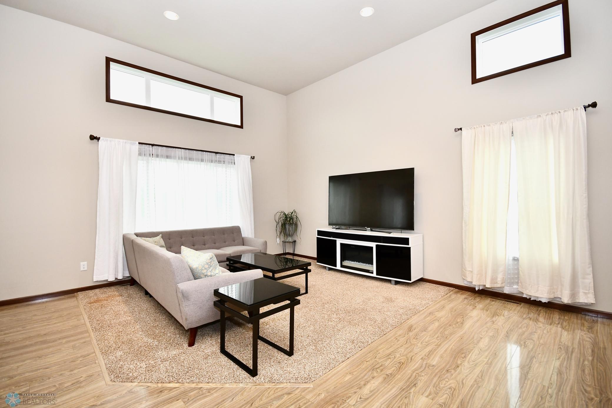 Bright & Airy Living Room on Main Level with Laminate Flooring