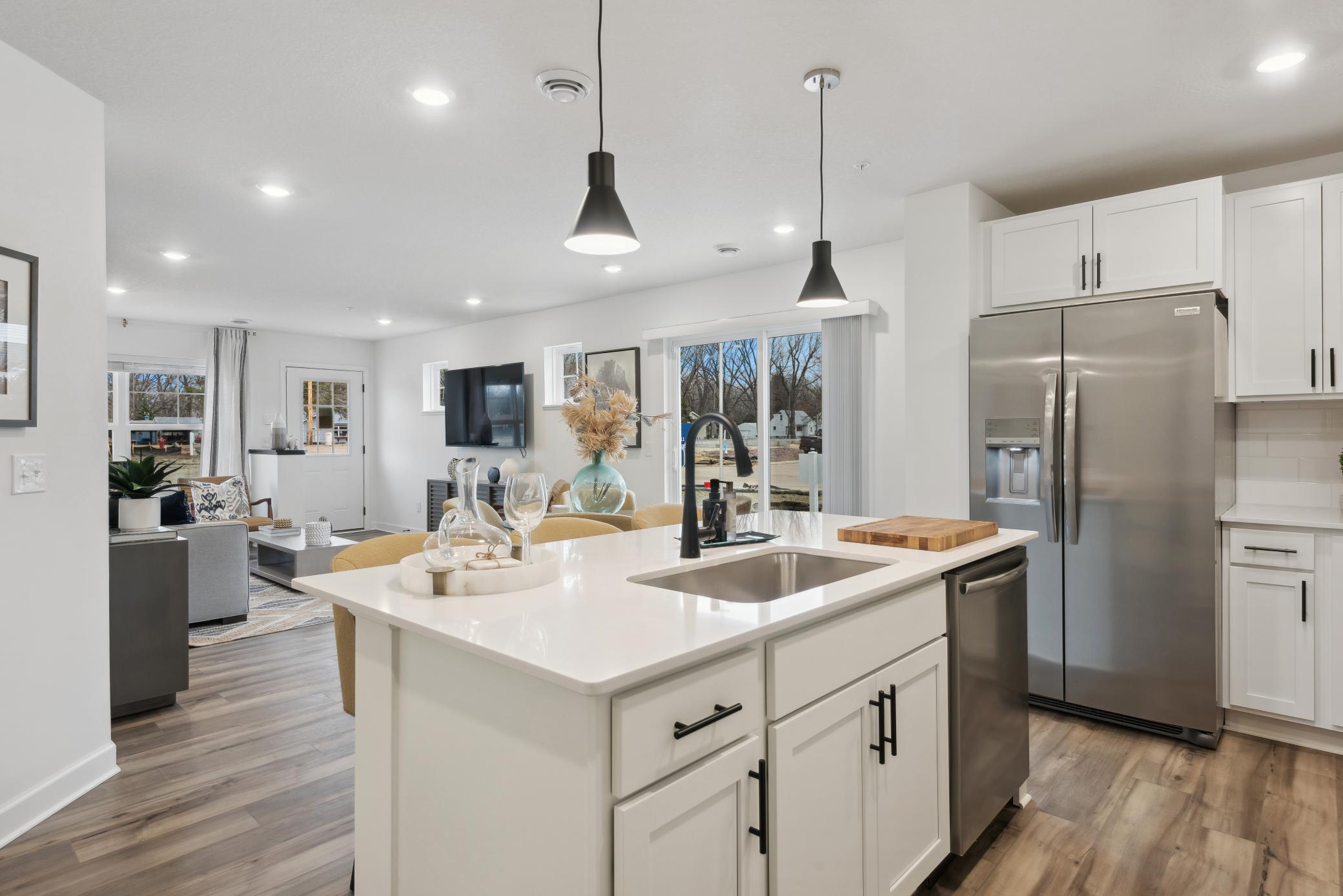 (*Photo of decorated model, actual homes colors and finishes will vary) Enjoy plenty of seating at the kitchen island and dining area adjacent to the kitchen. Perfect for entertaining or having a family meal together.