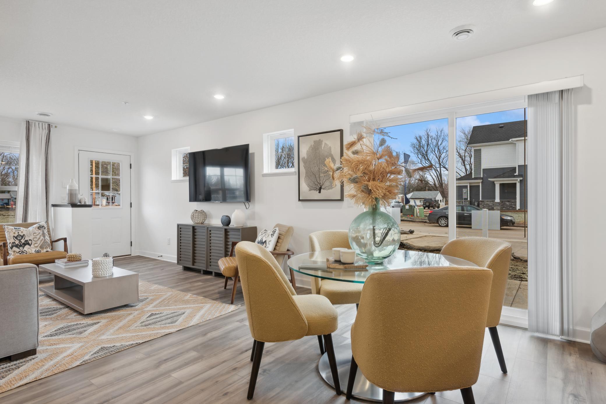 (*Photo of decorated model, actual homes colors and finishes will vary) Soaked in natural sunlight, the homes eat-in dining room has ample room for a dining table located in the heart of the home.