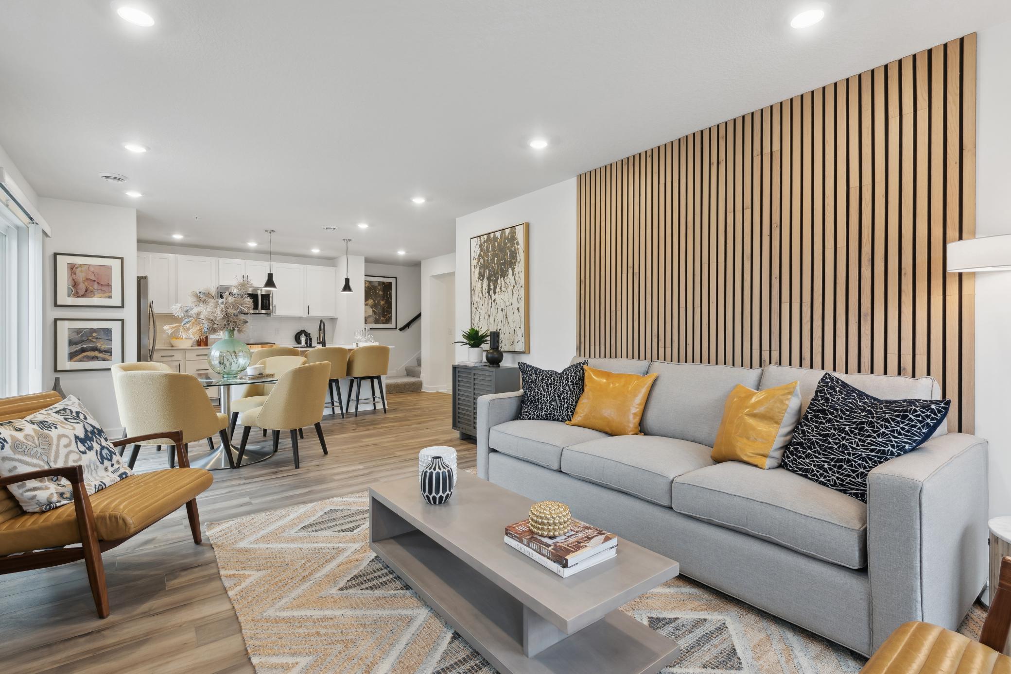 (*Photo of decorated model, actual homes colors and finishes will vary) This spacious and open family room area seamlessly connects to the kitchen