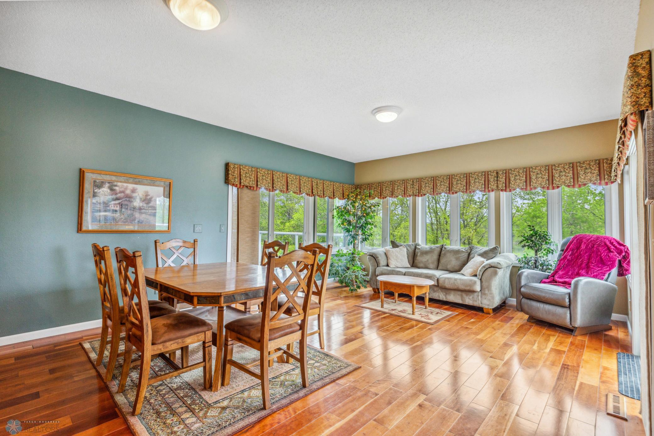 Dining & Sunroom - with windows (triple pane) on 3 sides, and a deck on the east and west side.