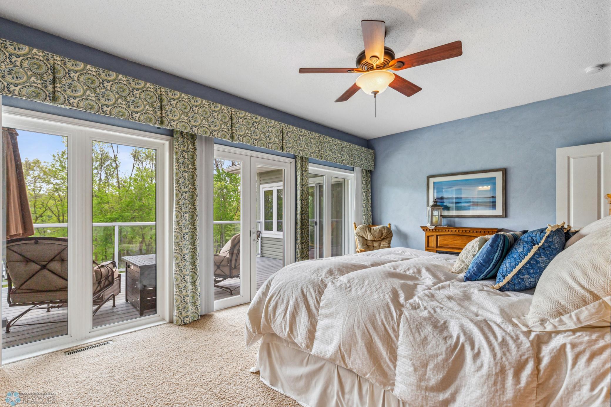 Primary Bedroom has sliding doors for incredible lake views and access to one of two decks. Also: large walk-in closet and private bath with separate soaking tub and shower.