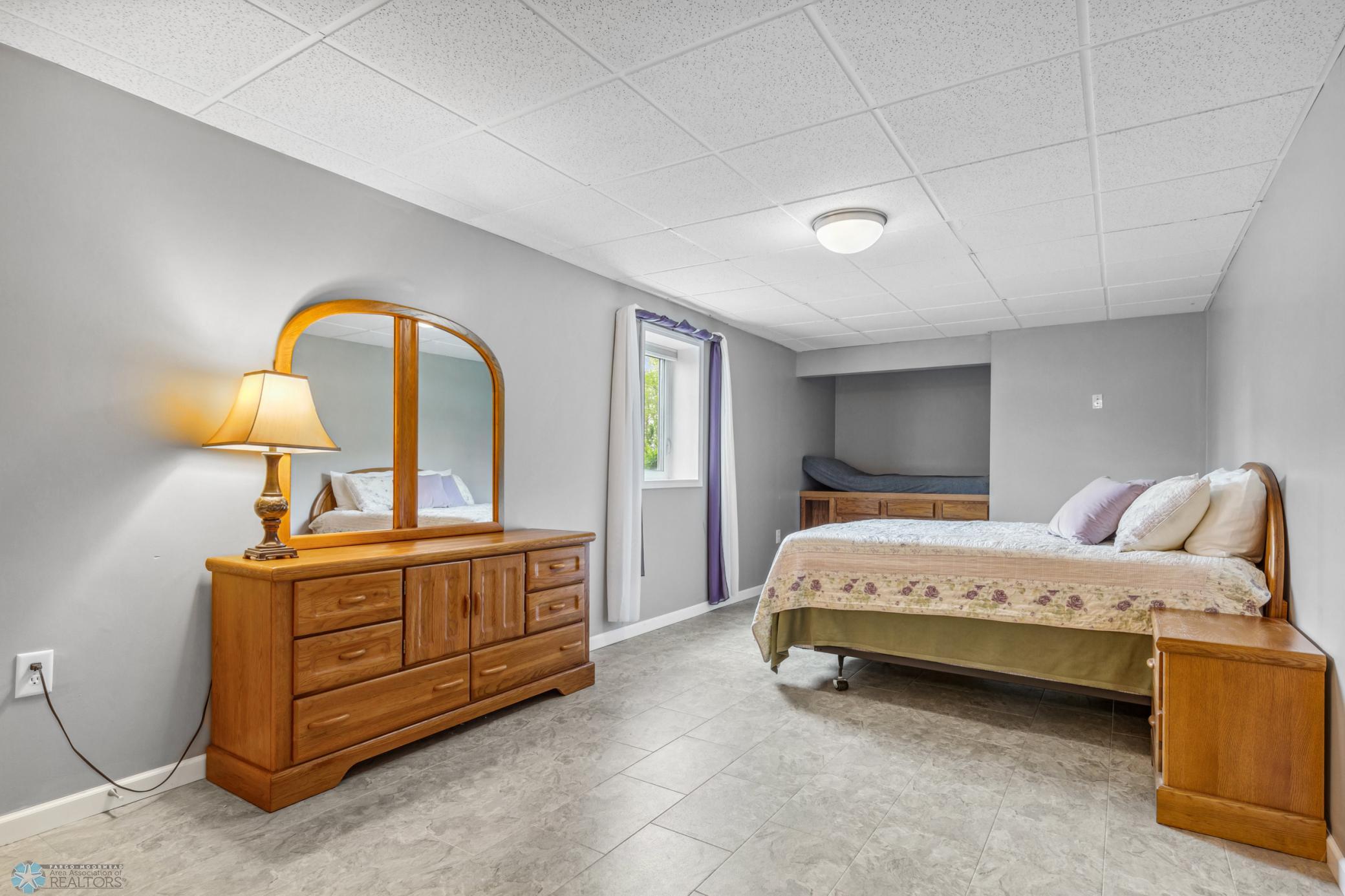 Basement Bedroom - has a "kid-cot" with storage cabinets beneath and Hollywood full bath.