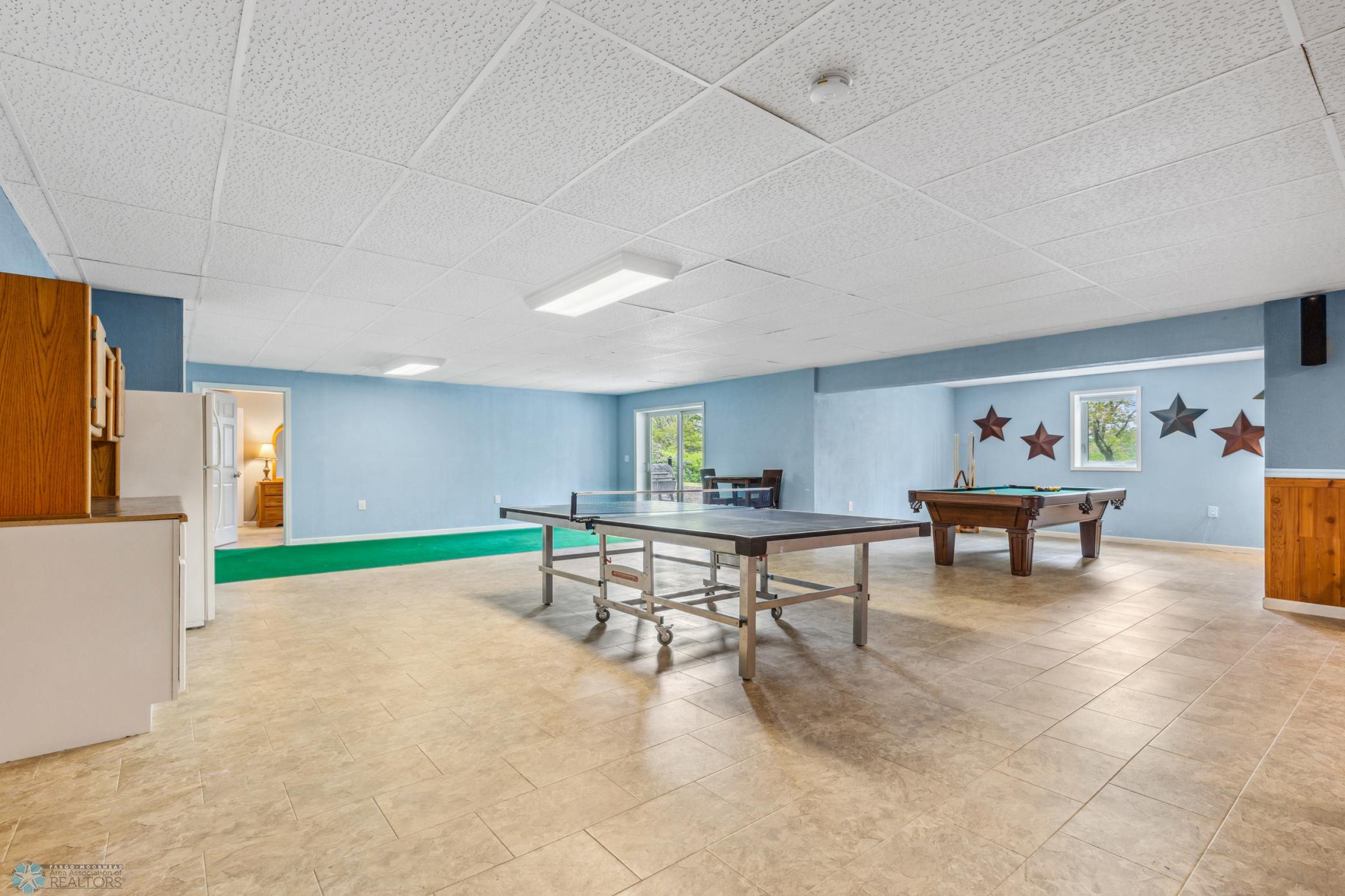 Great space for putting practice (green "carpet"), playing games, or accessing the outdoor patio & hot tub.