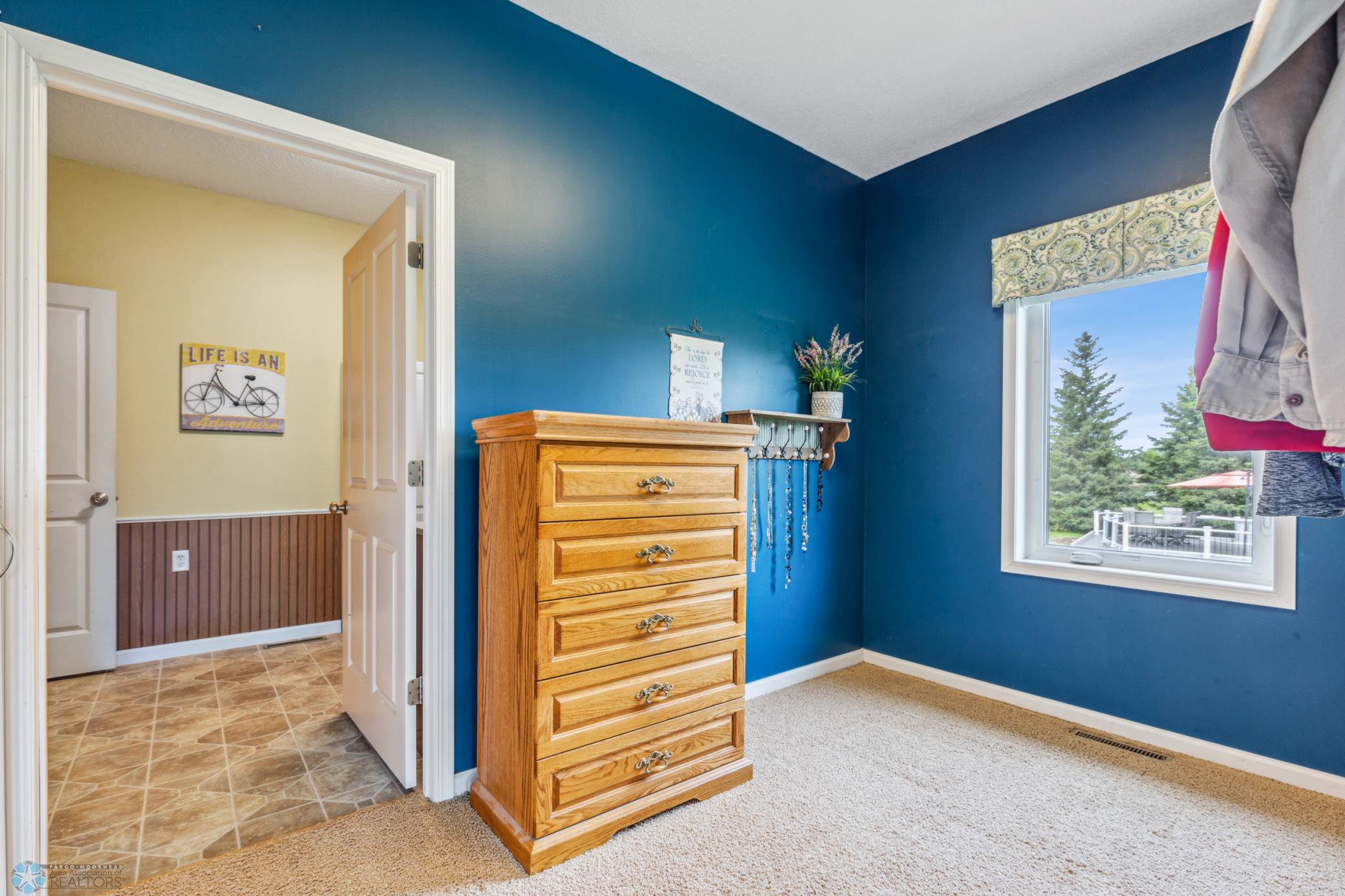 Primary walk-in closet, even has a window!