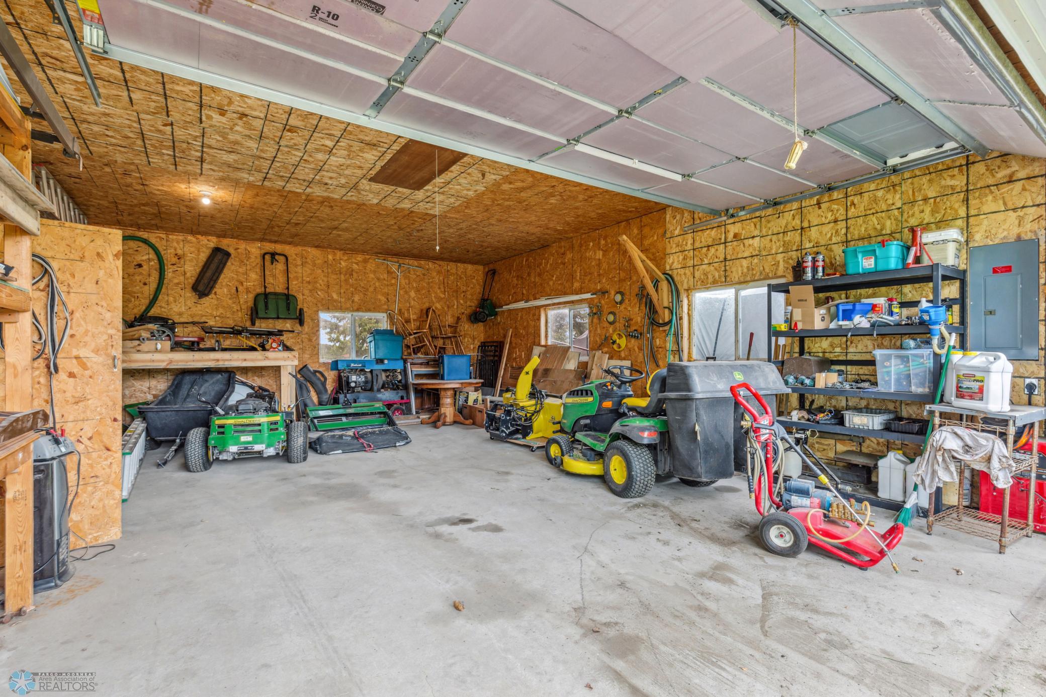 Double doors open between the heated workshop and the insulated storage/parking larger side of the shop.