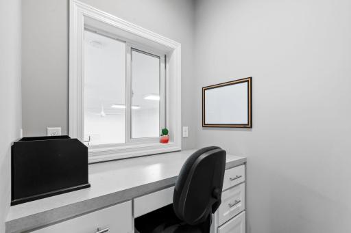 office nook off kitchen and view of sport court