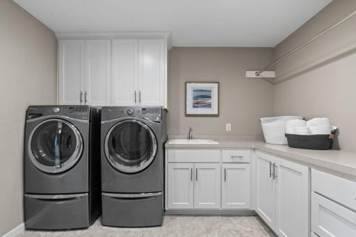 upper level laundry room with walkthrough to closet