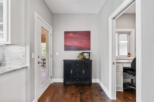 hall ofof kitchen, office nook and view of sport court