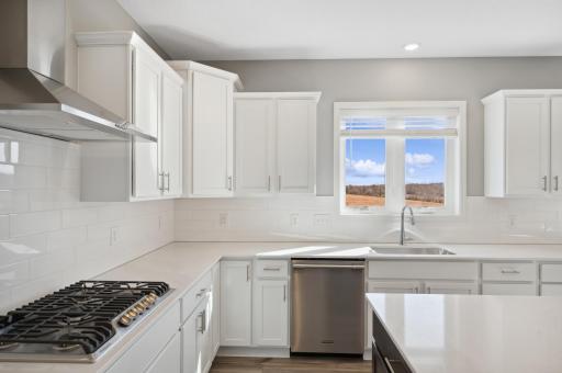 (Photo of similar home, finishes will vary) Welcome to the Itasca! This spacious kitchen includes a large center island, quartz countertops, recessed lighting, LVP wood floors, stainless appliances and more.