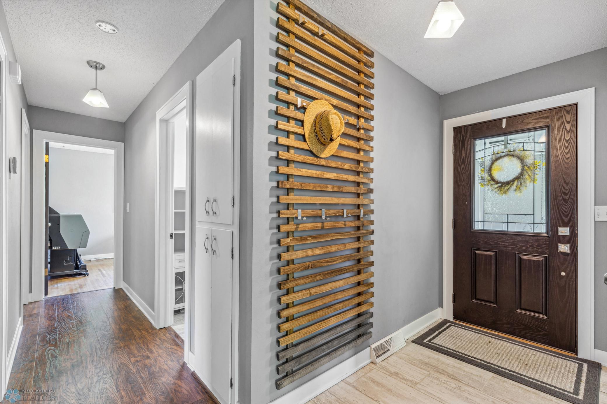 Foyer allows access to kitchen, living area and hallway towards bedrooms and main bath.