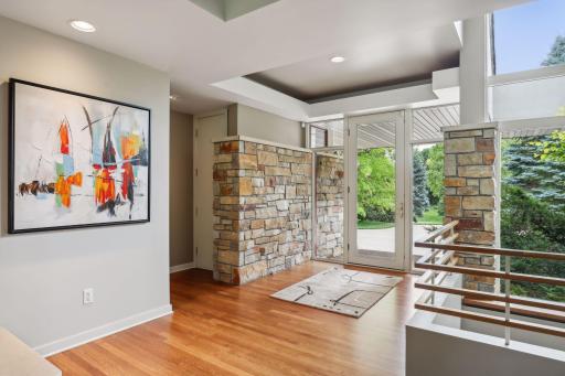 Front foyer brings the outside in with continuous architectural stone detail