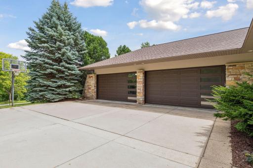 4 stall garage features architectural garage doors with windows for design and natural lighting. Garage is also heated and has built-in storage cabinets