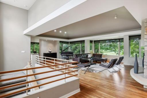 Wood floors, lighting and an abundance of windows create an amazing great room