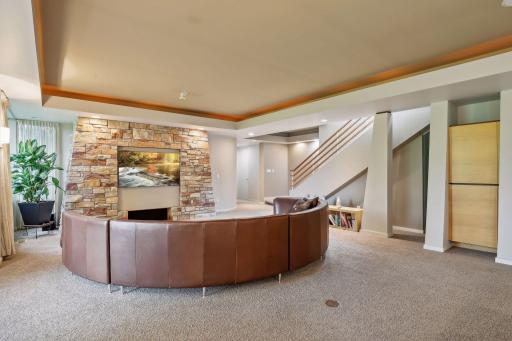 Family Room features same stone as upper level foyer and fireplace surround