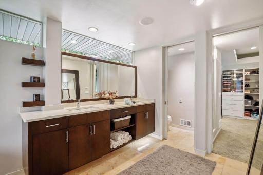 Vanity looking toward water closet and walk-in closet