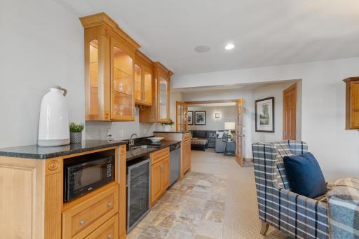 Wet bar with wine fridge, microwave and dishwasher
