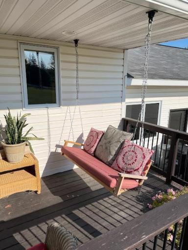 One of the two front deck swings for relaxing and enjoying the beautiful yard.