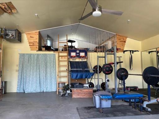 The 4 car heated & insulated garage with space for exercise equipment, storage or cars. There is a fun loft with a round Marvin window! Large workroom/storage area under the loft.